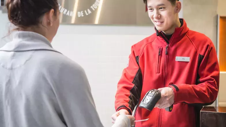 A person gets their ticket scanned by CN Tower staff