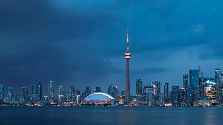 Toronto skyline at night with CN Tower lit up