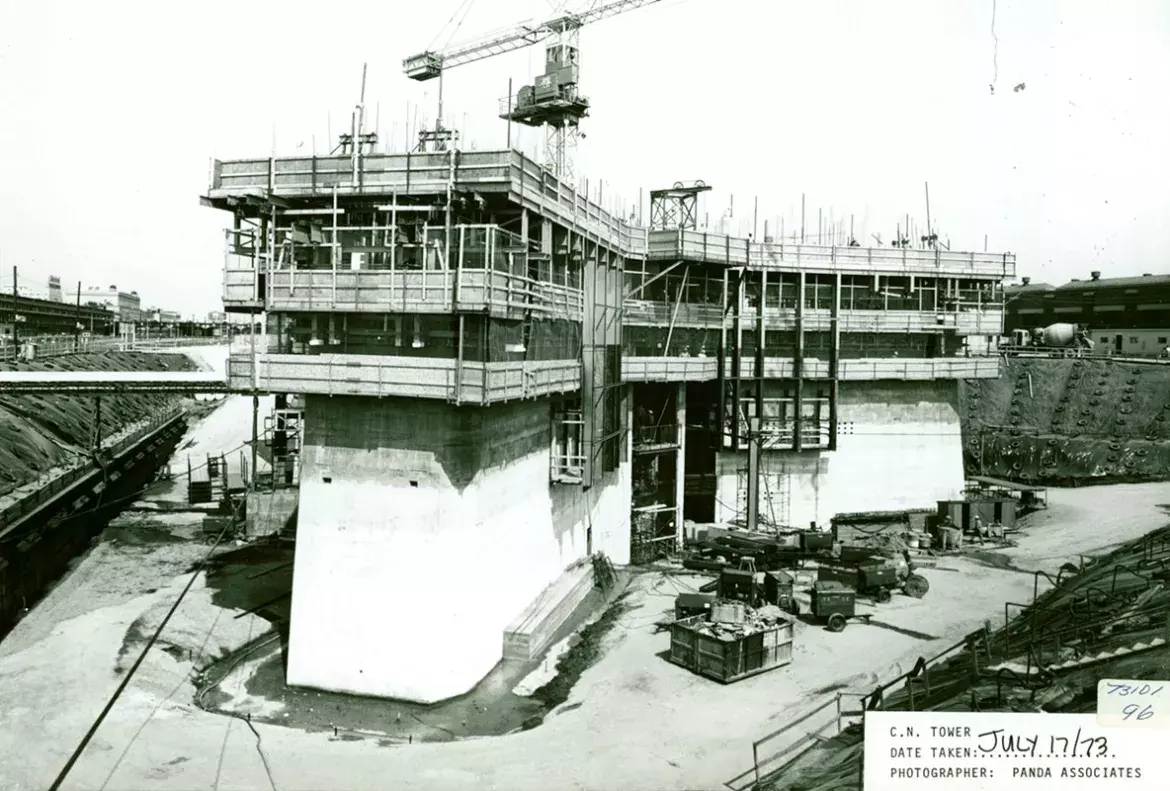 A crane helps to build the base of the CN Tower, covered in scaffolding, in July 1973.